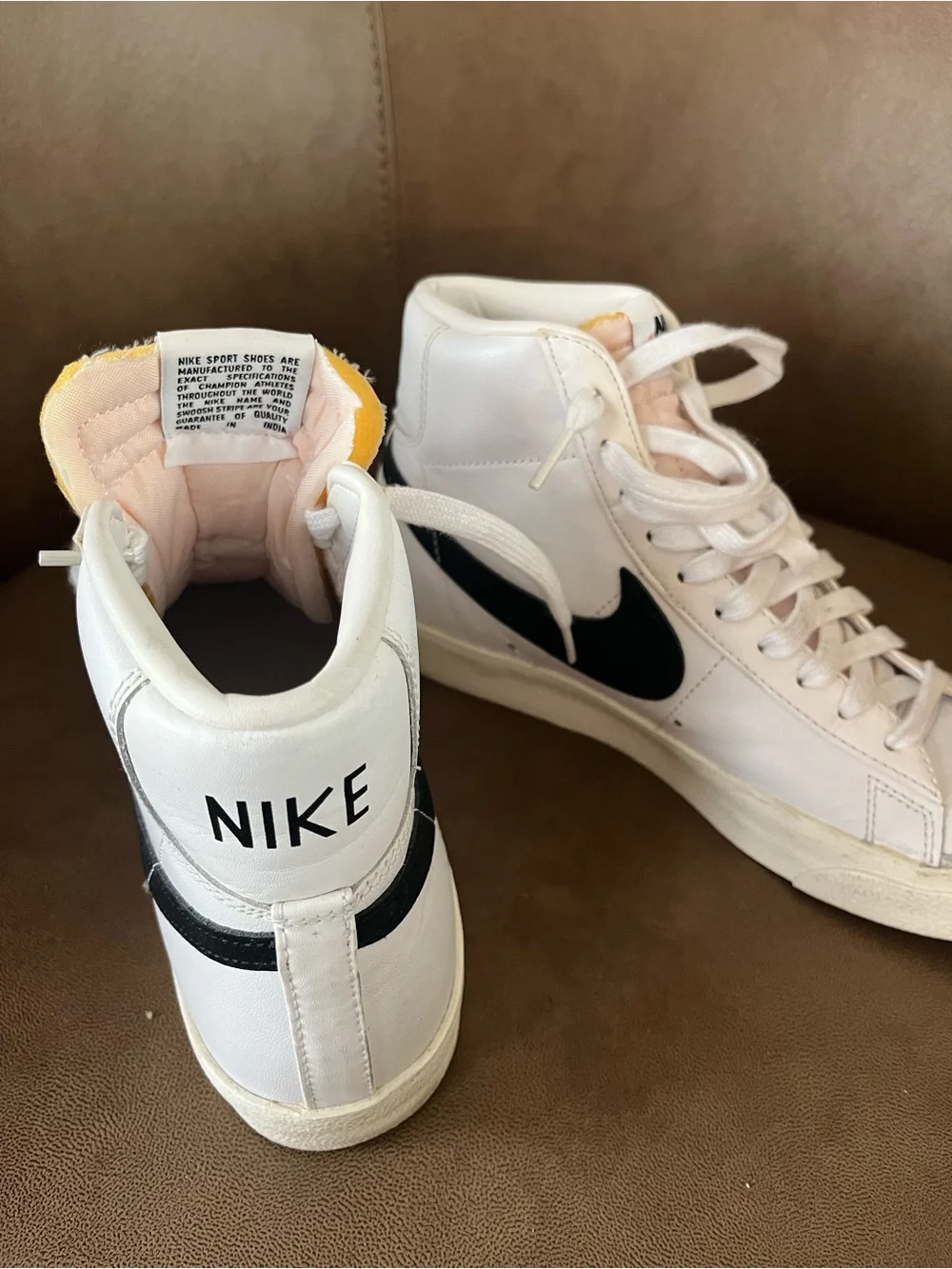 Women’s Nike White High-Top Sneakers with Black Swoosh